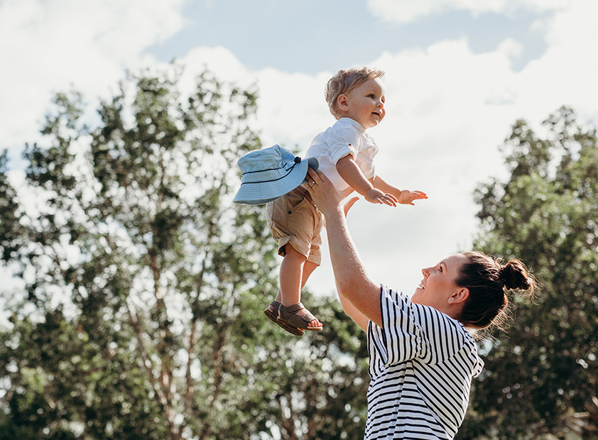 Mother lifting child into the air